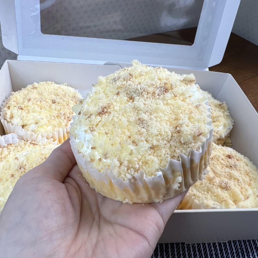 コストコ ダブルチーズケーキ6個入の1個を手に持って大きさを紹介している写真